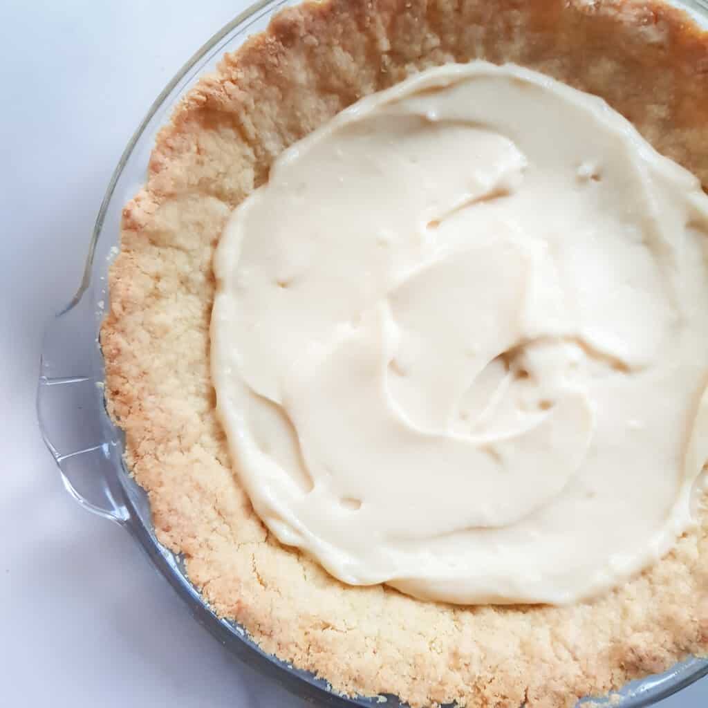 Spread custard along the bottom of the pie crust.
