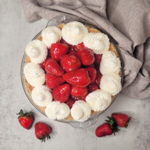 Strawberry custard pie next to other strawberries.