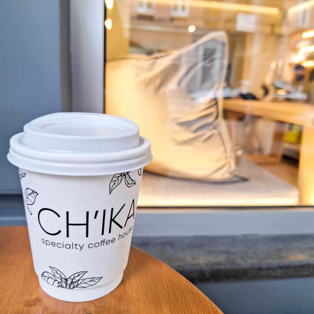 A paper cup that says chika specialty coffee house in Tbilisi