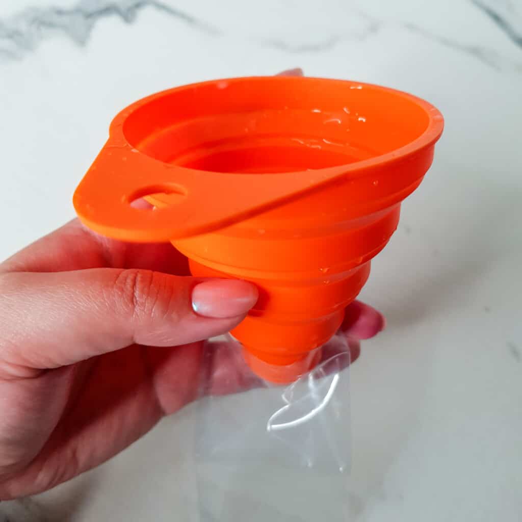 Ice candy plastic bag with an orange funnel on top