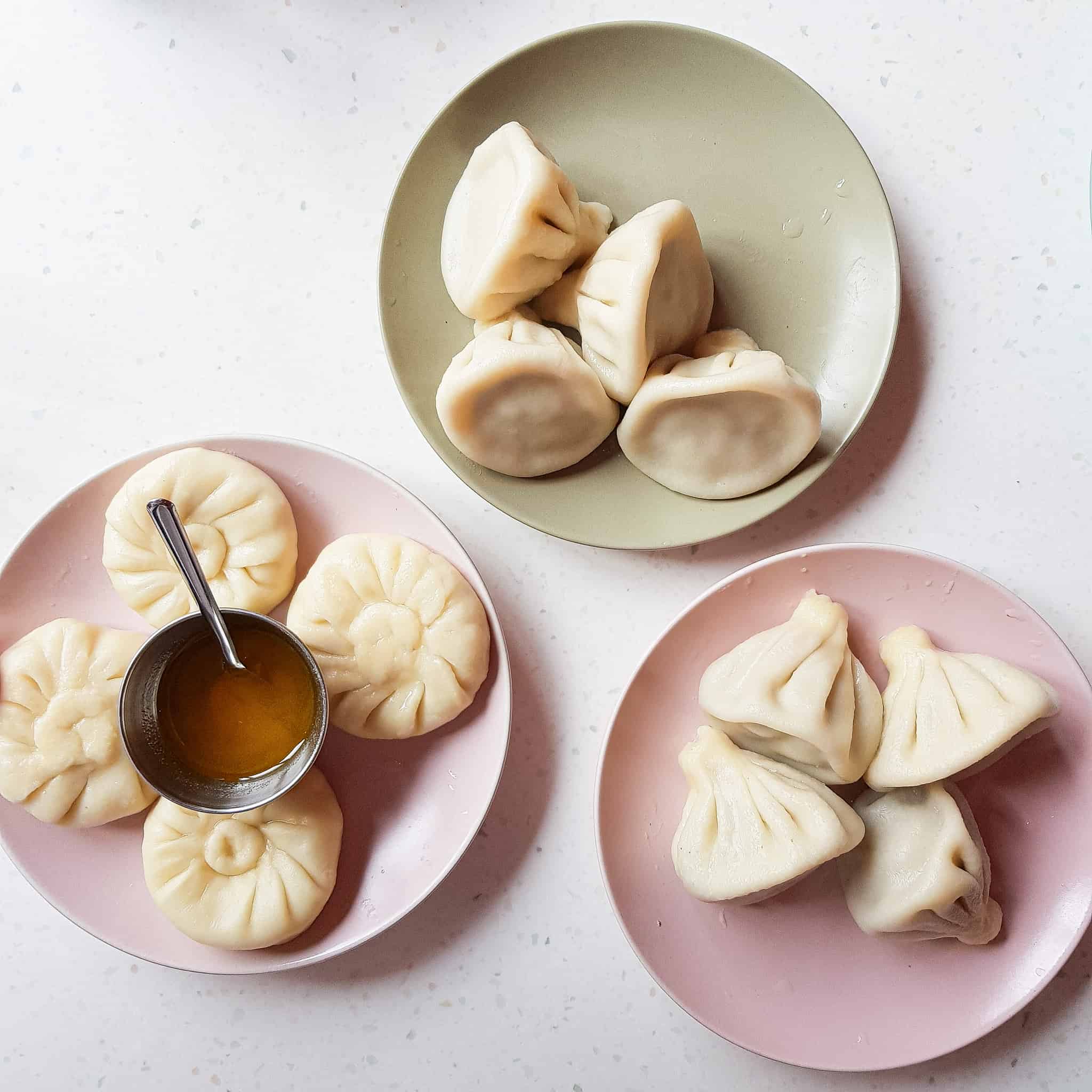 Different colors plates of khinkali, or Georgian dumplings