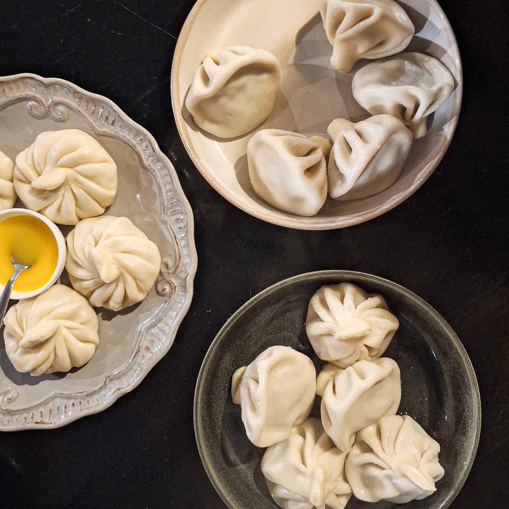 Different plates of khinkali, also known as Georgian dumplings