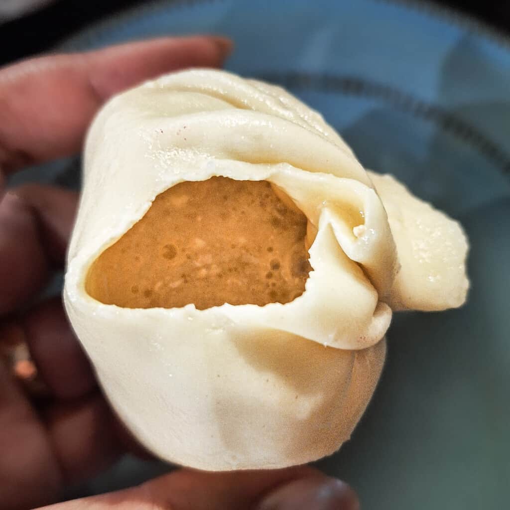 The inside of a special dumpling filled with melted cheese