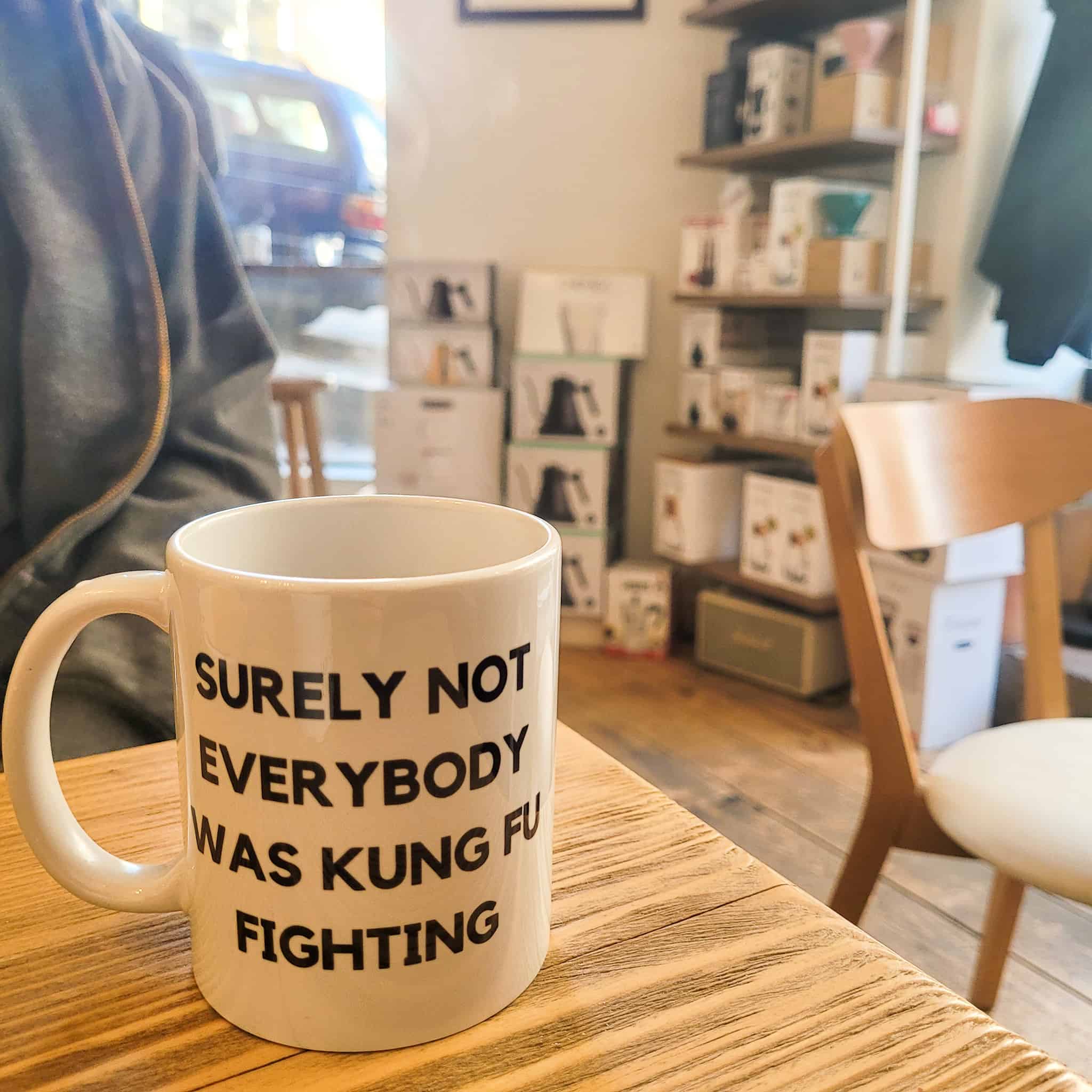 A cup that says "Surely not everybody was Kung Fu fighting"