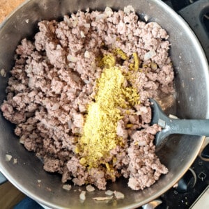 Browned ground meat and chicken powder in a pot