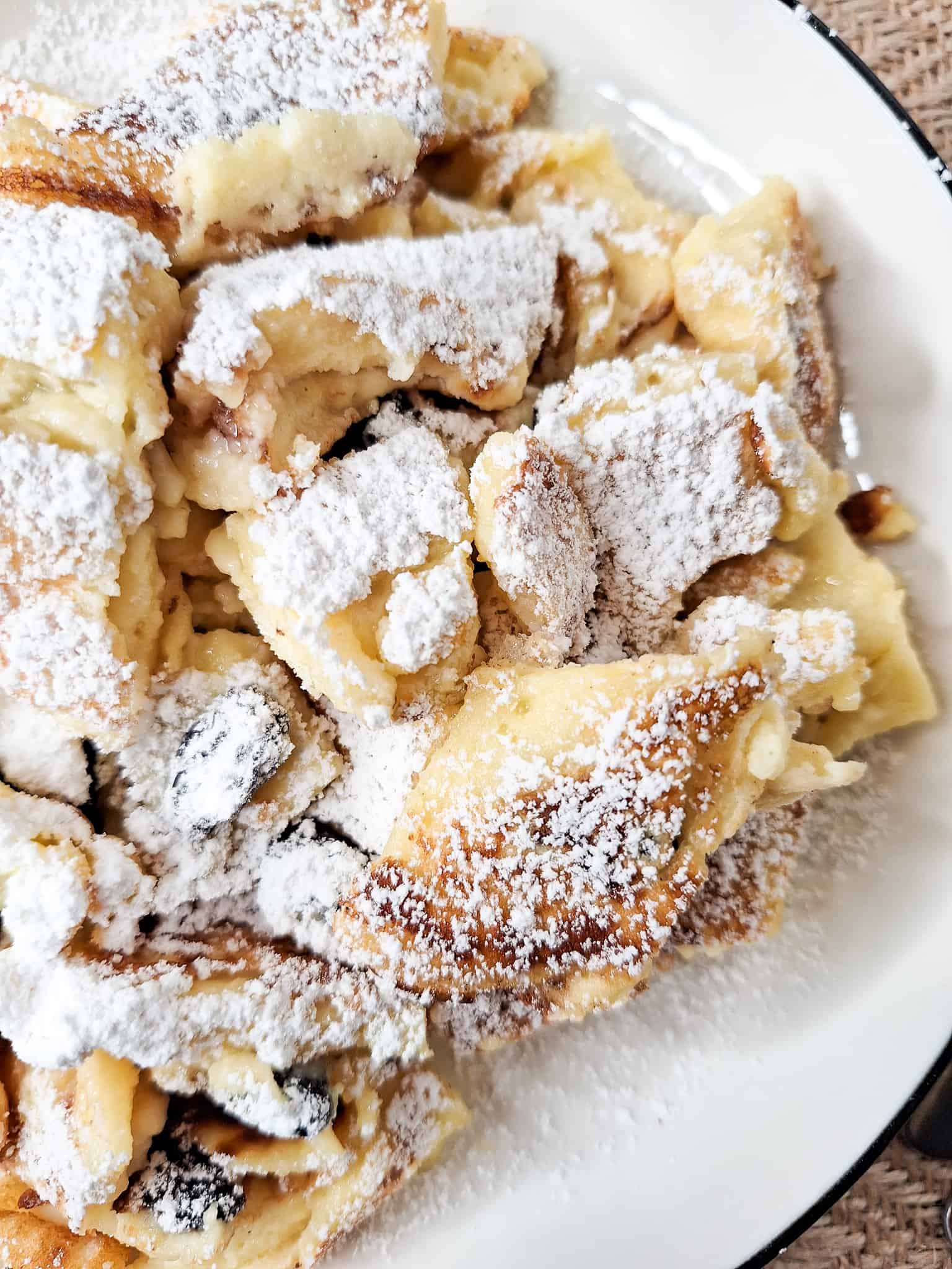 Close up of Austrian Kaiserschmarrn or torn pancakes in a white plate