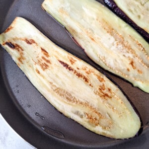 Slices of eggplants in a frying pan