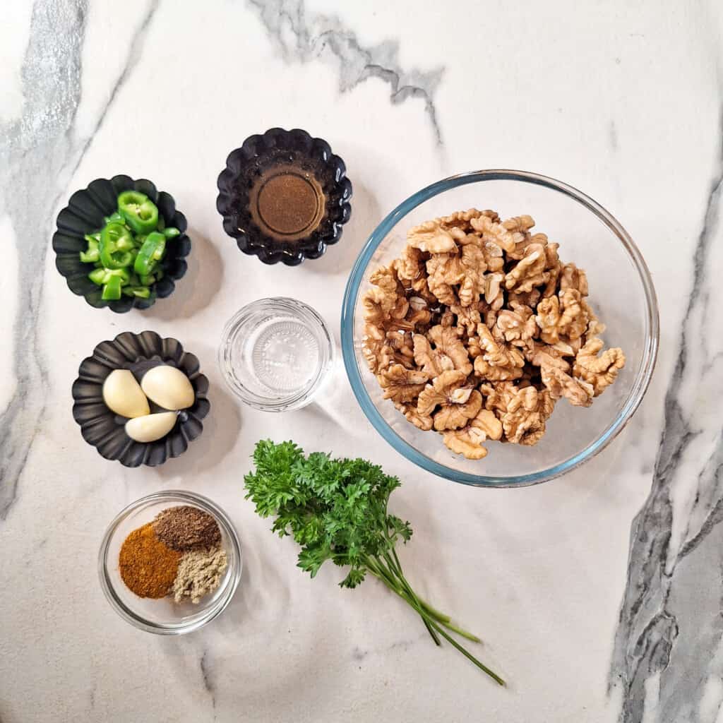 ingredients for Georgian walnut paste: walnuts, parsley, chilies, vinegar, garlic, water, and seasoning