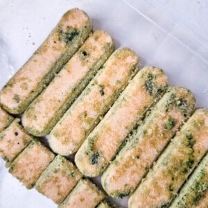 Ladyfingers for matcha tiramisu dipped in matcha green tea laid out in a container