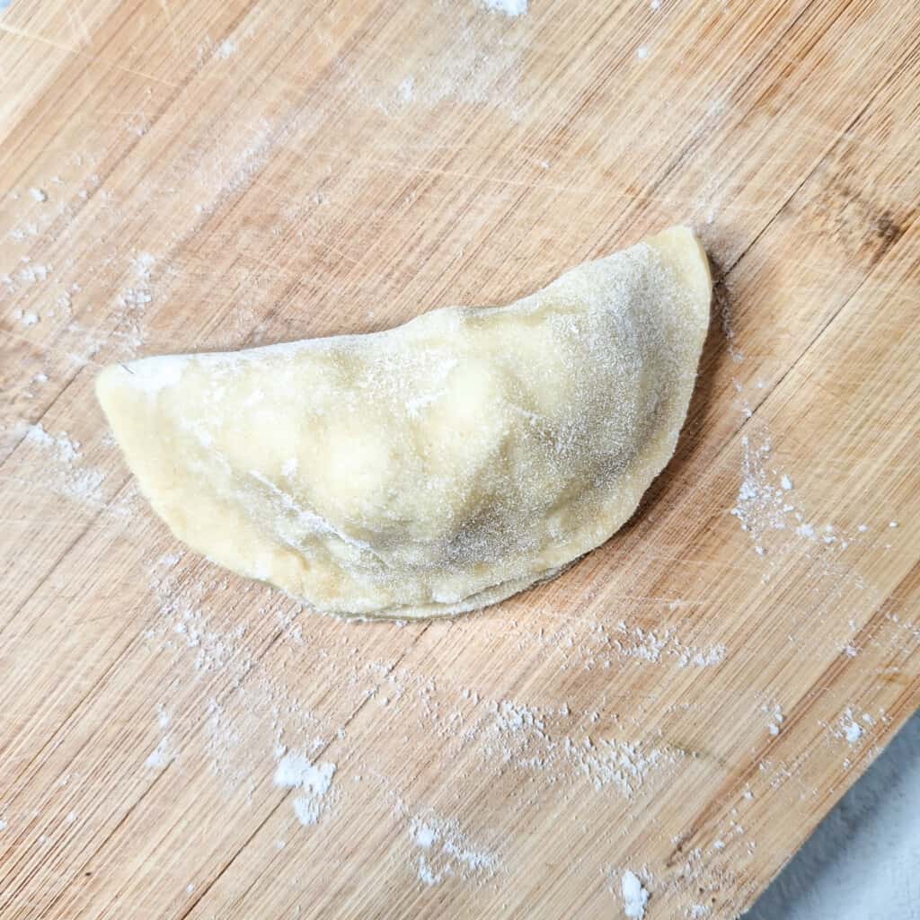 Closed empanada raw dough